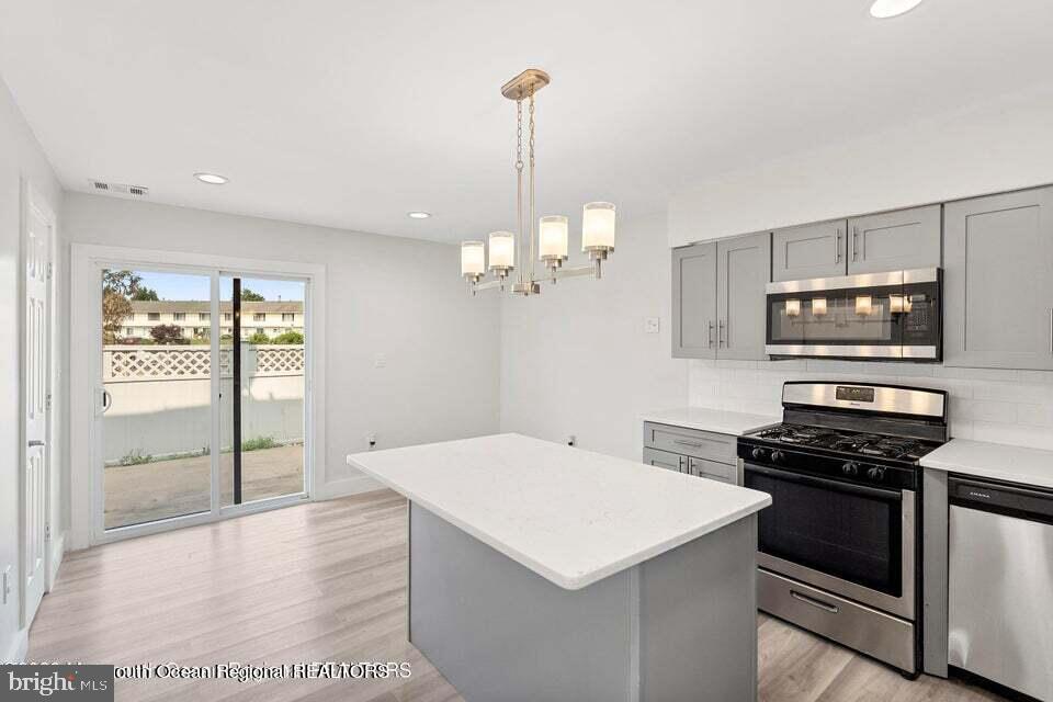 19 Creek Road Brick, NJ 08724 - Photo 3 of 10 a kitchen that has a sink a stove and a refrigerator