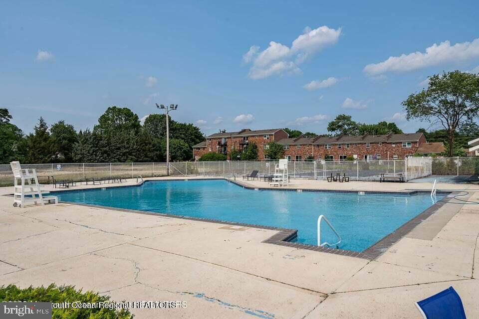 19 Creek Road Brick, NJ 08724 - Photo 10 of 10 a view of swimming pool with outdoor seating and city view