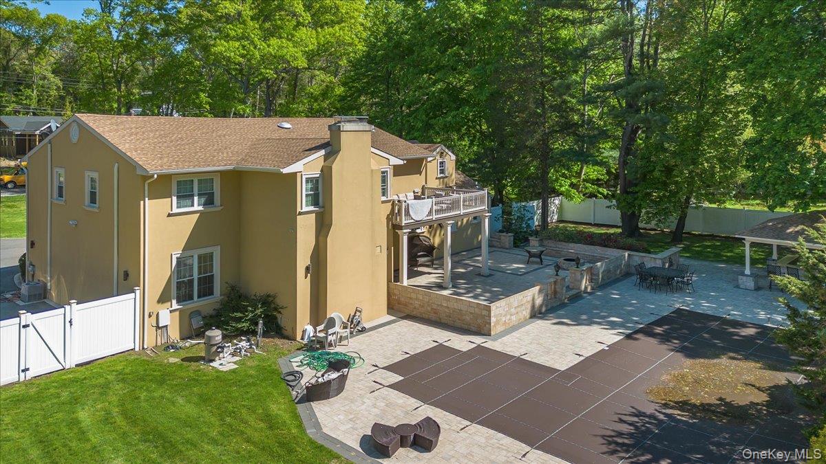 626 Caledonia Road Dix Hills, NY 11746 - Photo 41 of 49 a view of a patio with table and chairs potted plants and large tree