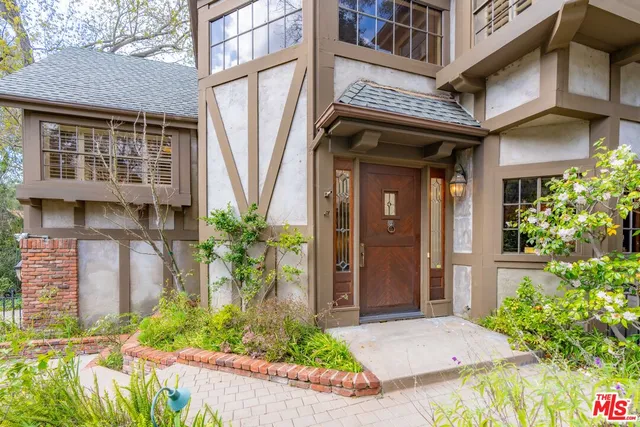 a front view of a building with potted plants