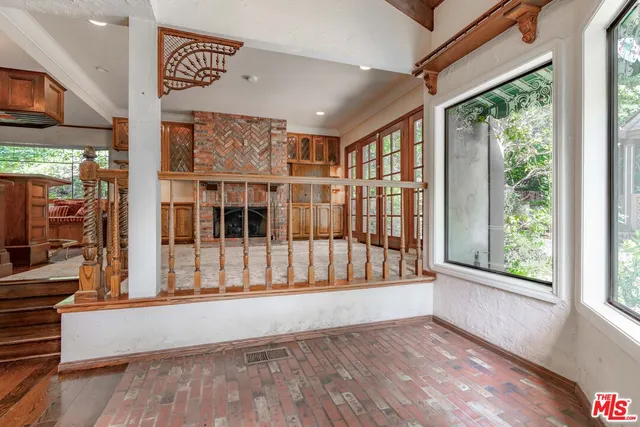a view of an empty room and wooden floor