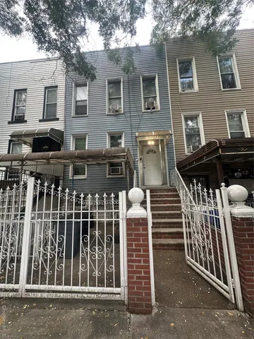 a view of a house with wooden fence
