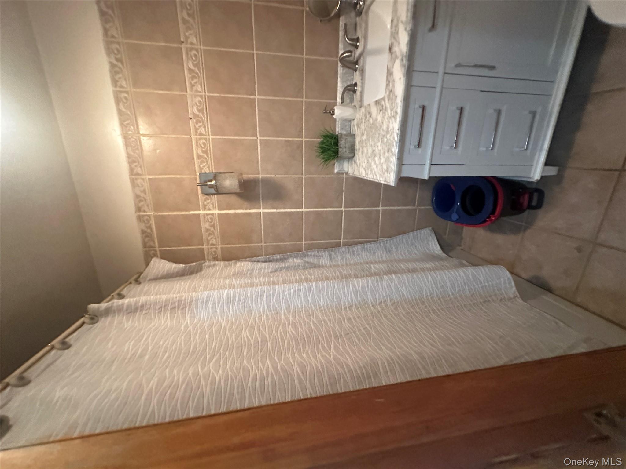 1245 Madison Street Brooklyn, NY 11221 - Photo 13 of 15 a bathroom with a granite countertop sink a toilet and shower