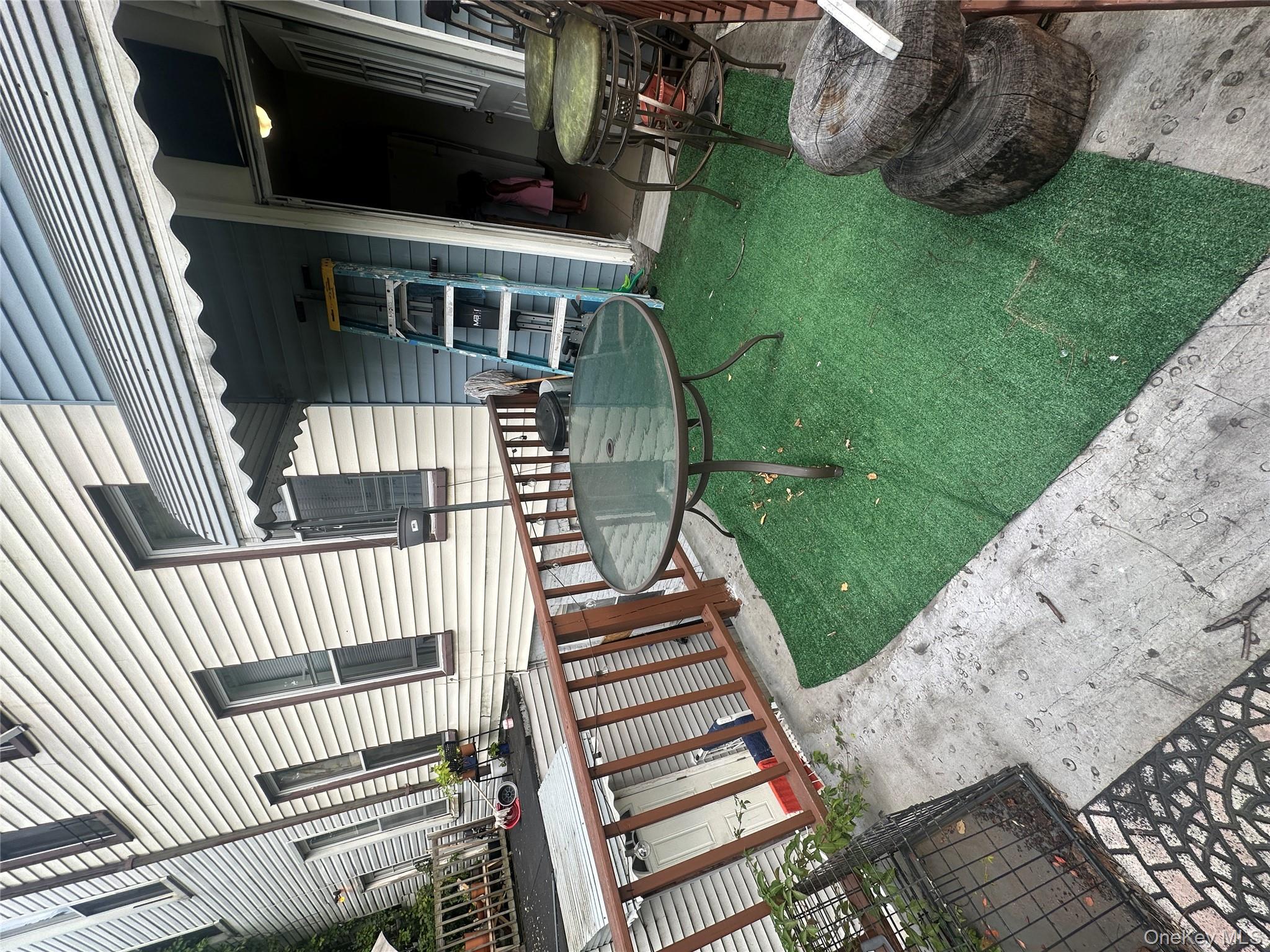 1245 Madison Street Brooklyn, NY 11221 - Photo 14 of 15 a view of a chair and table in backyard of the house