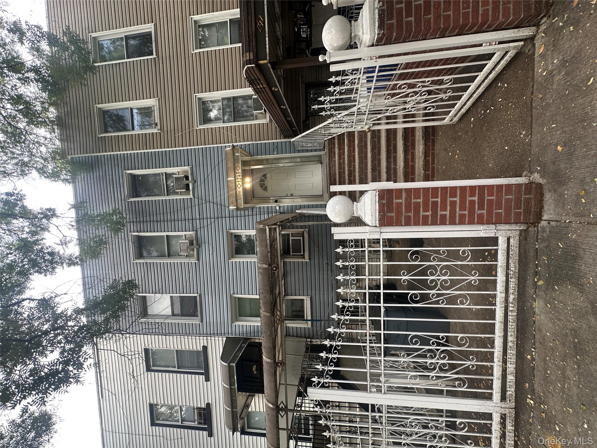 1245 Madison Street Brooklyn, NY 11221 - Photo 15 of 15 a view of a house with wooden fence