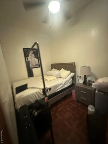 a bed sitting in a bedroom next to a window