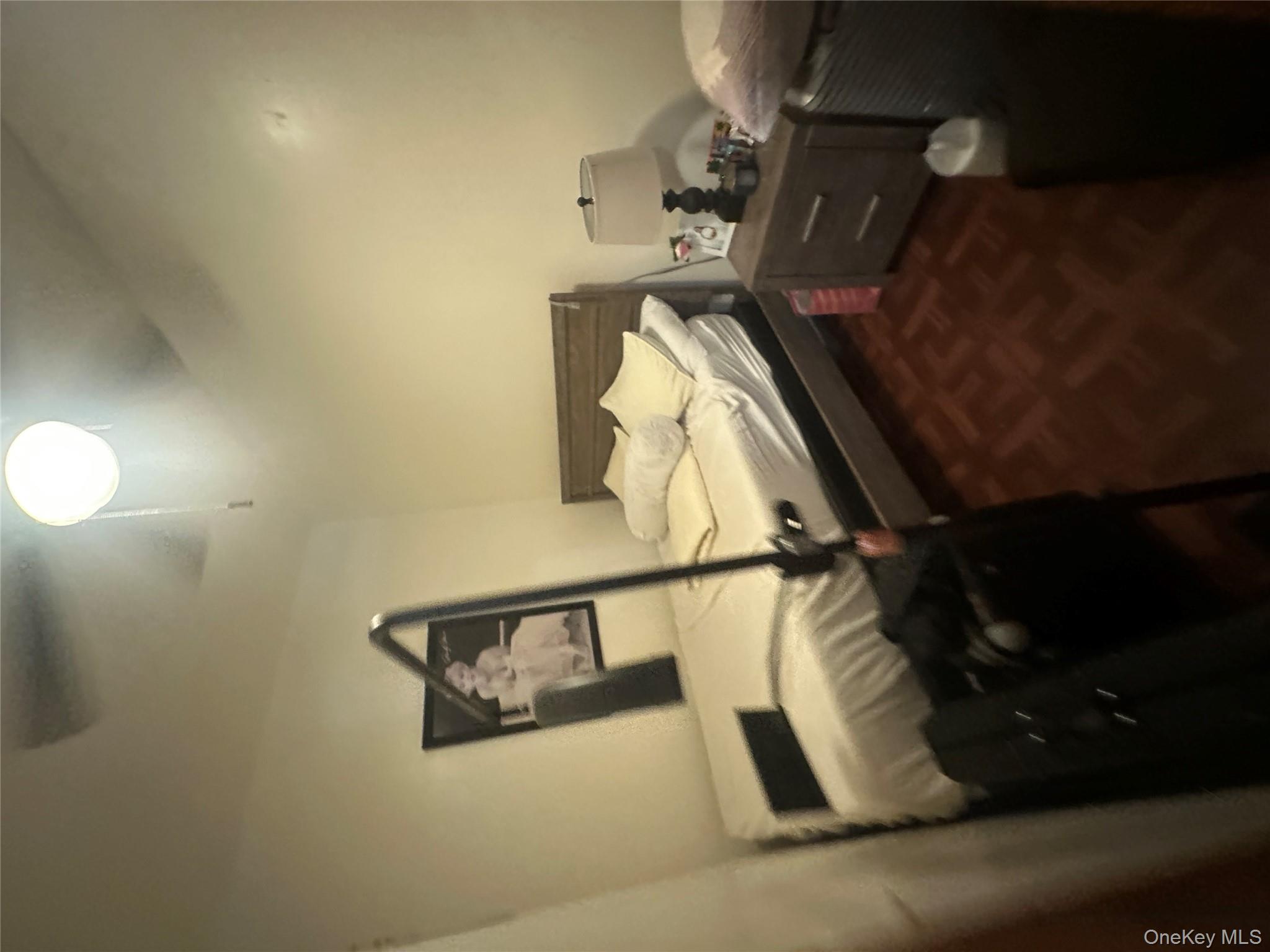 1245 Madison Street Brooklyn, NY 11221 - Photo 5 of 15 a bed sitting in a bedroom next to a window