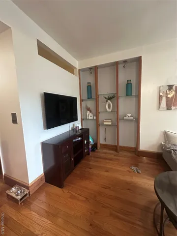 a living room with flat screen tv and furniture