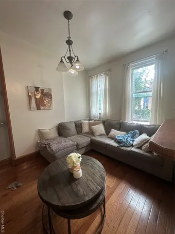 a living room with furniture and a chandelier