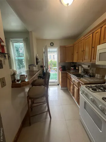 a kitchen with a stove a sink and a refrigerator