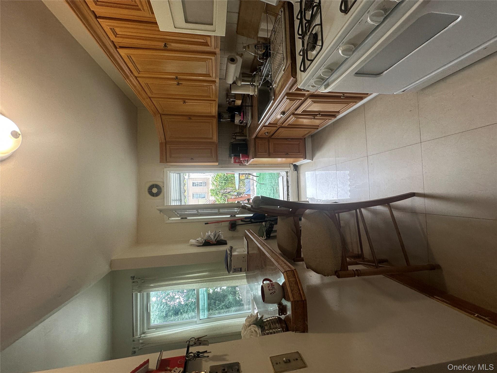 1245 Madison Street Brooklyn, NY 11221 - Photo 9 of 15 a kitchen with a stove a sink and a refrigerator