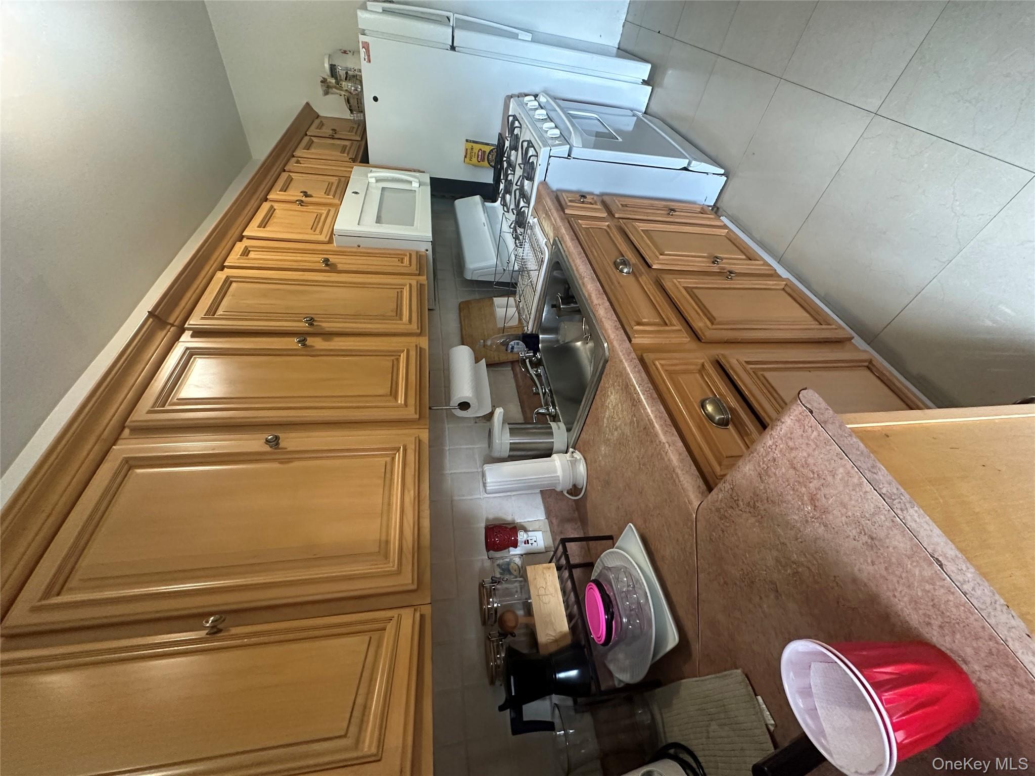 1245 Madison Street Brooklyn, NY 11221 - Photo 10 of 15 a kitchen with stainless steel appliances granite countertop a sink stove and cabinets
