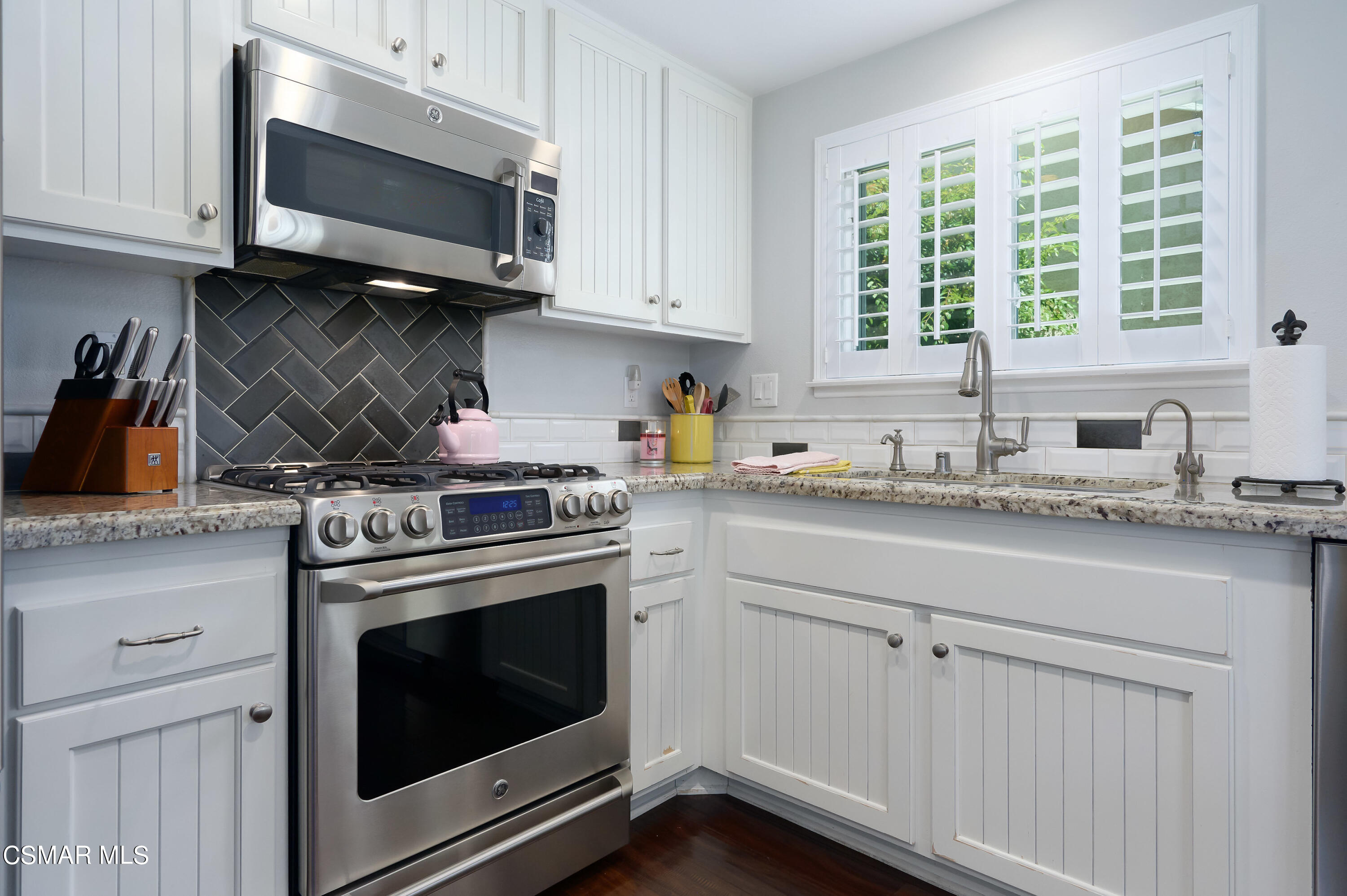 4798 Talmadge Road Moorpark, CA 93021 - Photo 22 of 65 a kitchen with stainless steel appliances granite countertop grey cabinets a stove a sink and a microwave