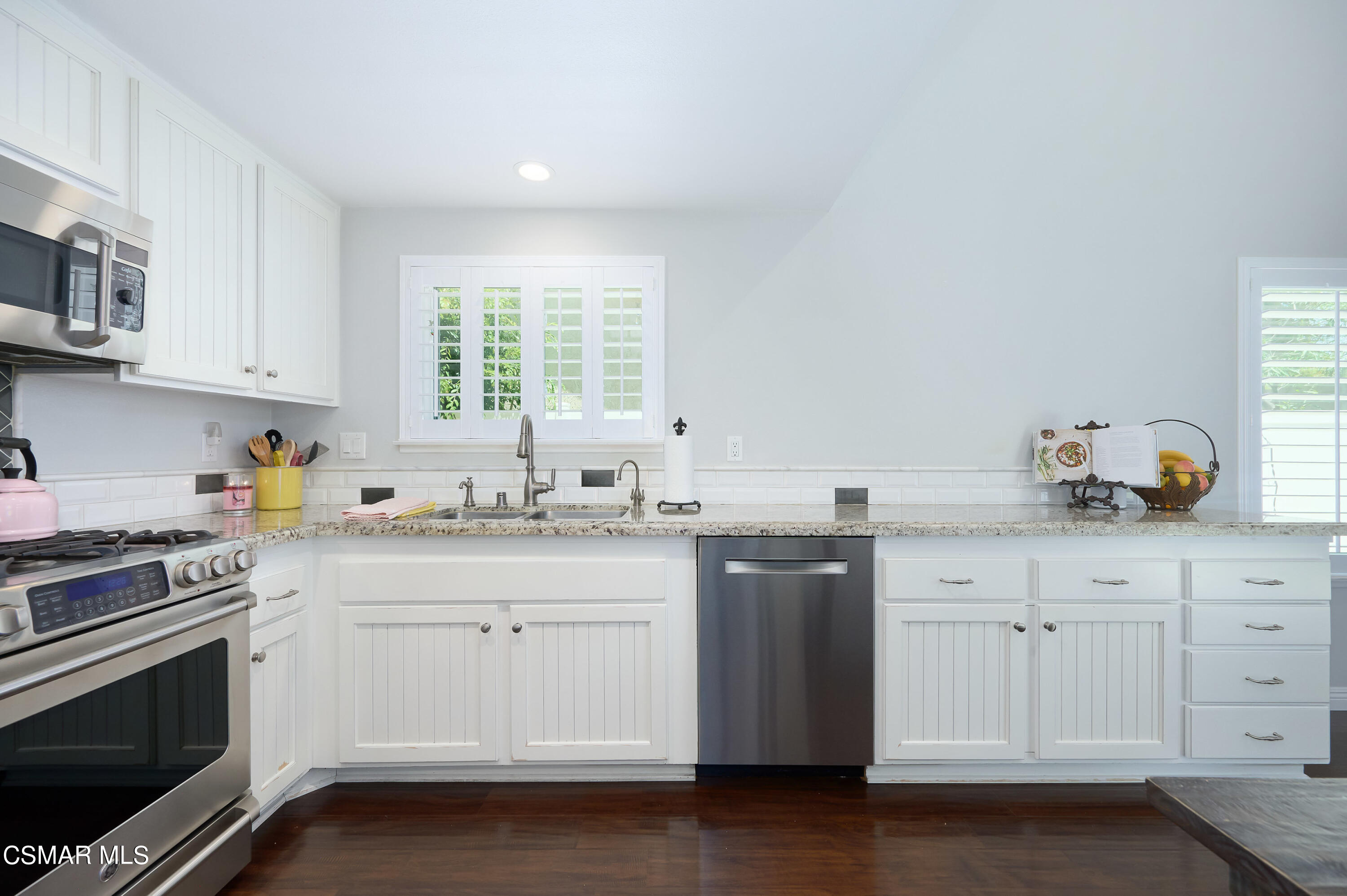 4798 Talmadge Road Moorpark, CA 93021 - Photo 23 of 65 a kitchen with granite countertop white cabinets and white appliances