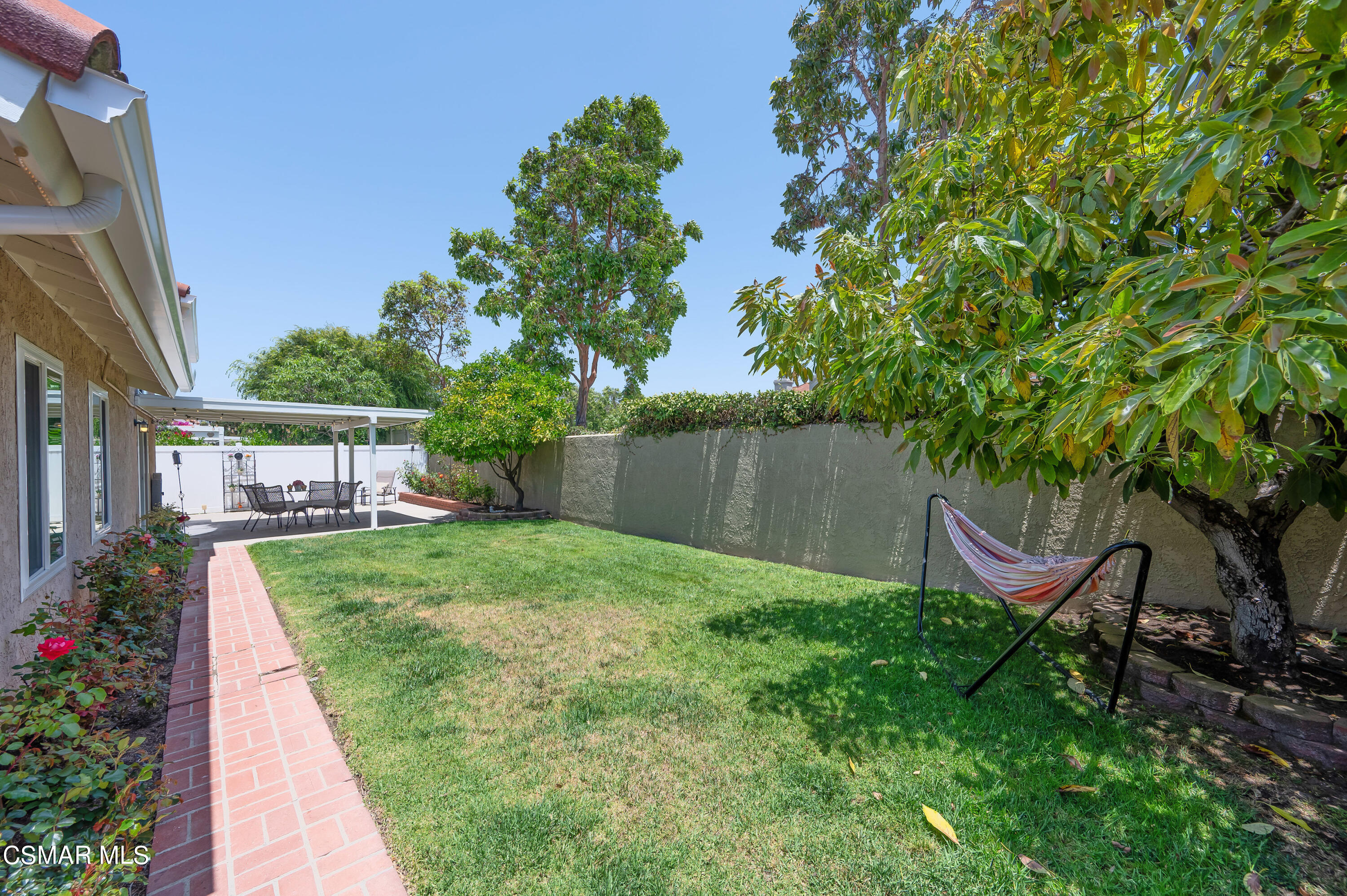 4798 Talmadge Road Moorpark, CA 93021 - Photo 57 of 65 a view of a backyard with table and chairs and potted plants