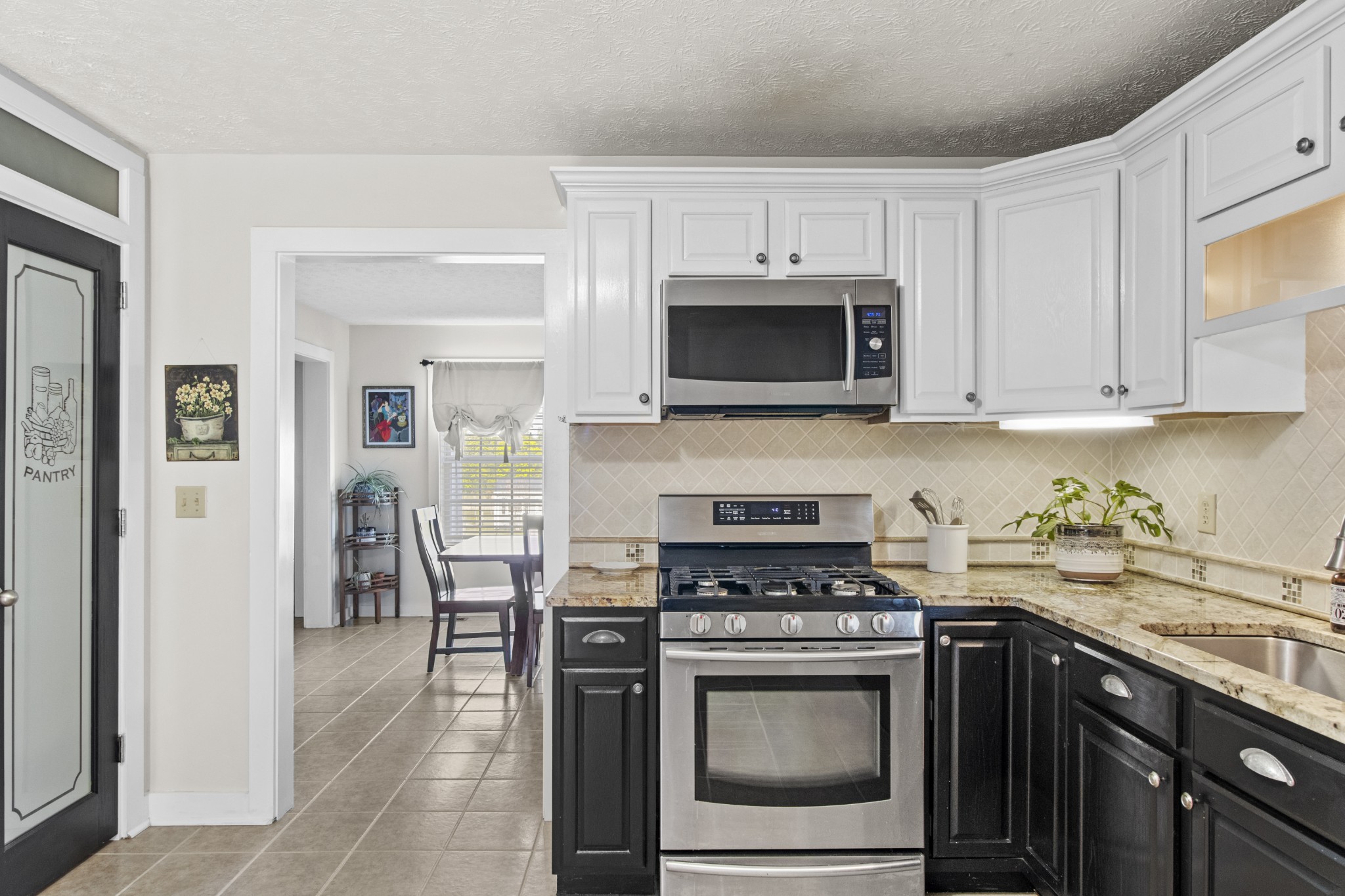 884 Tidwell Road Burns, TN 37029 - Photo 13 of 28 a kitchen with stainless steel appliances a stove a microwave a sink and cabinets