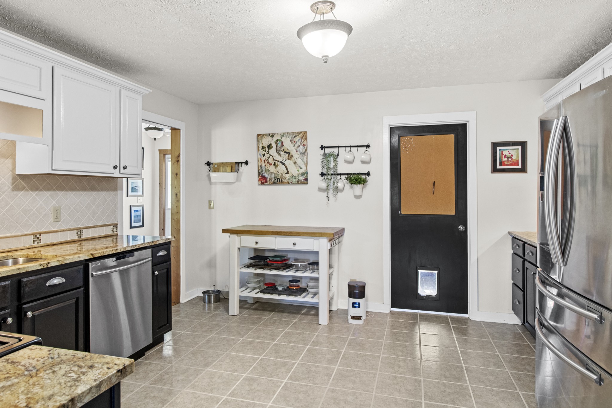 884 Tidwell Road Burns, TN 37029 - Photo 14 of 28 a view of kitchen with stainless steel appliances granite countertop a refrigerator and a stove top oven