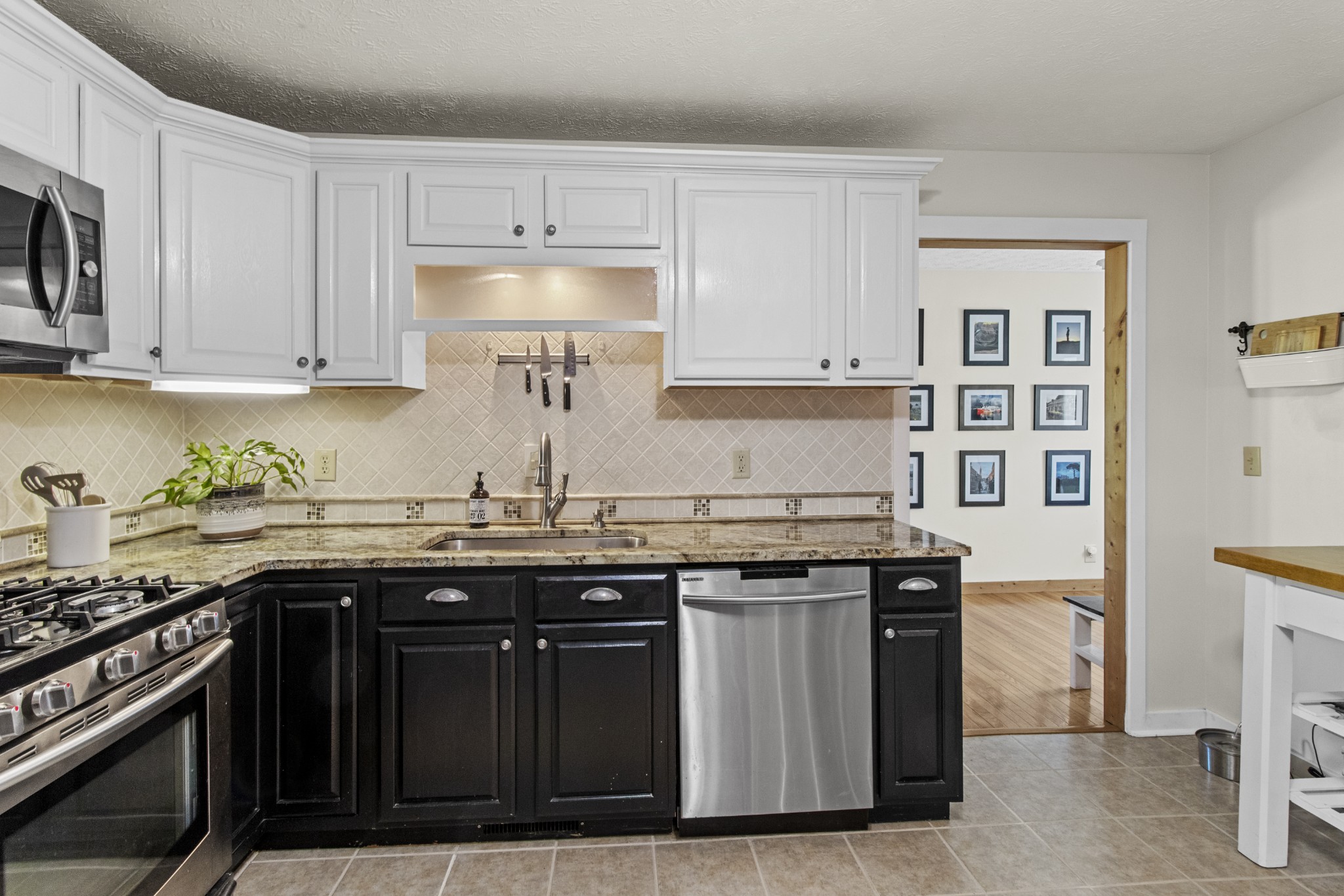 884 Tidwell Road Burns, TN 37029 - Photo 15 of 28 a kitchen with stainless steel appliances granite countertop a stove and a sink