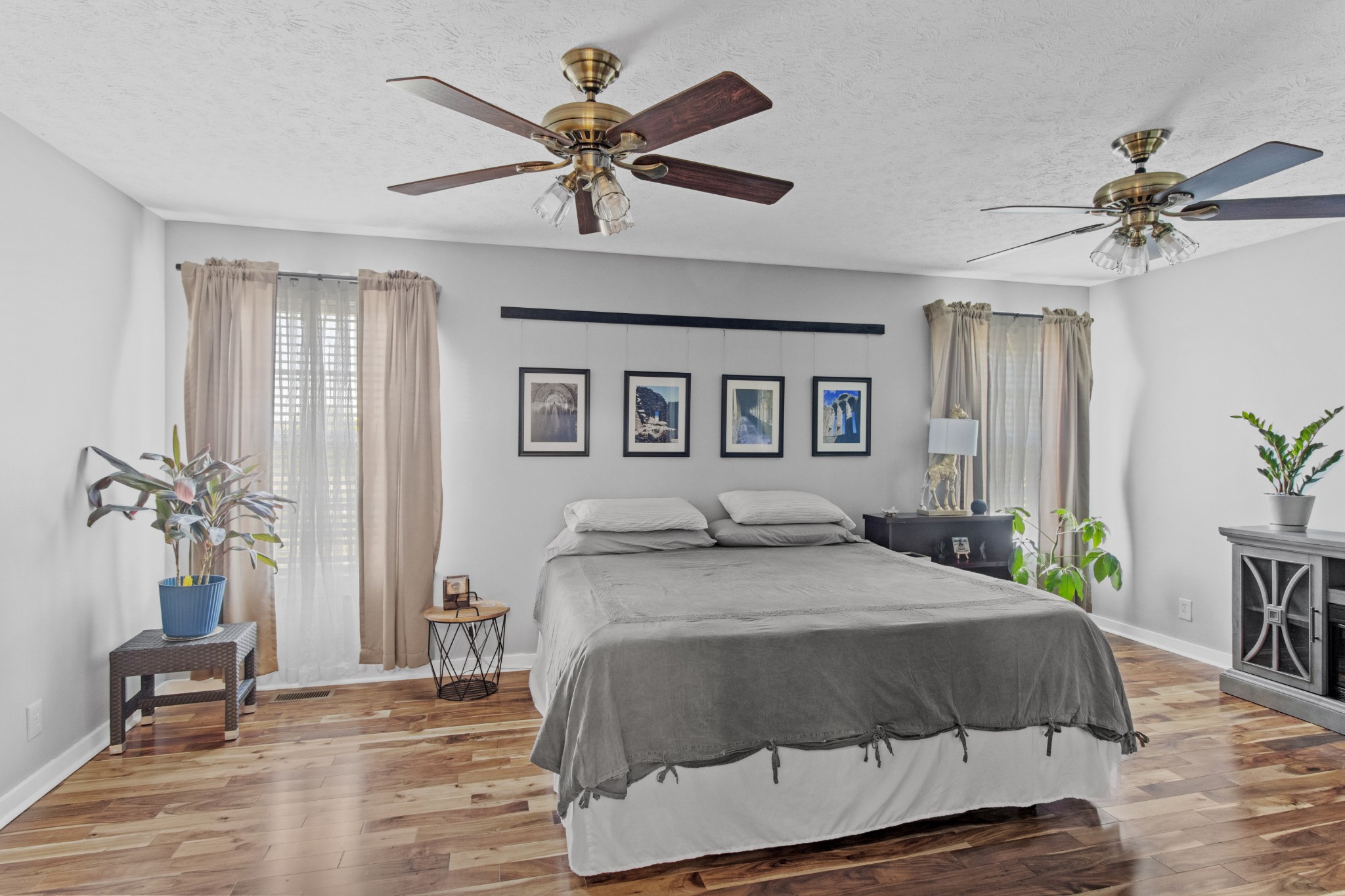 884 Tidwell Road Burns, TN 37029 - Photo 18 of 28 a bedroom with a large bed and a chandelier