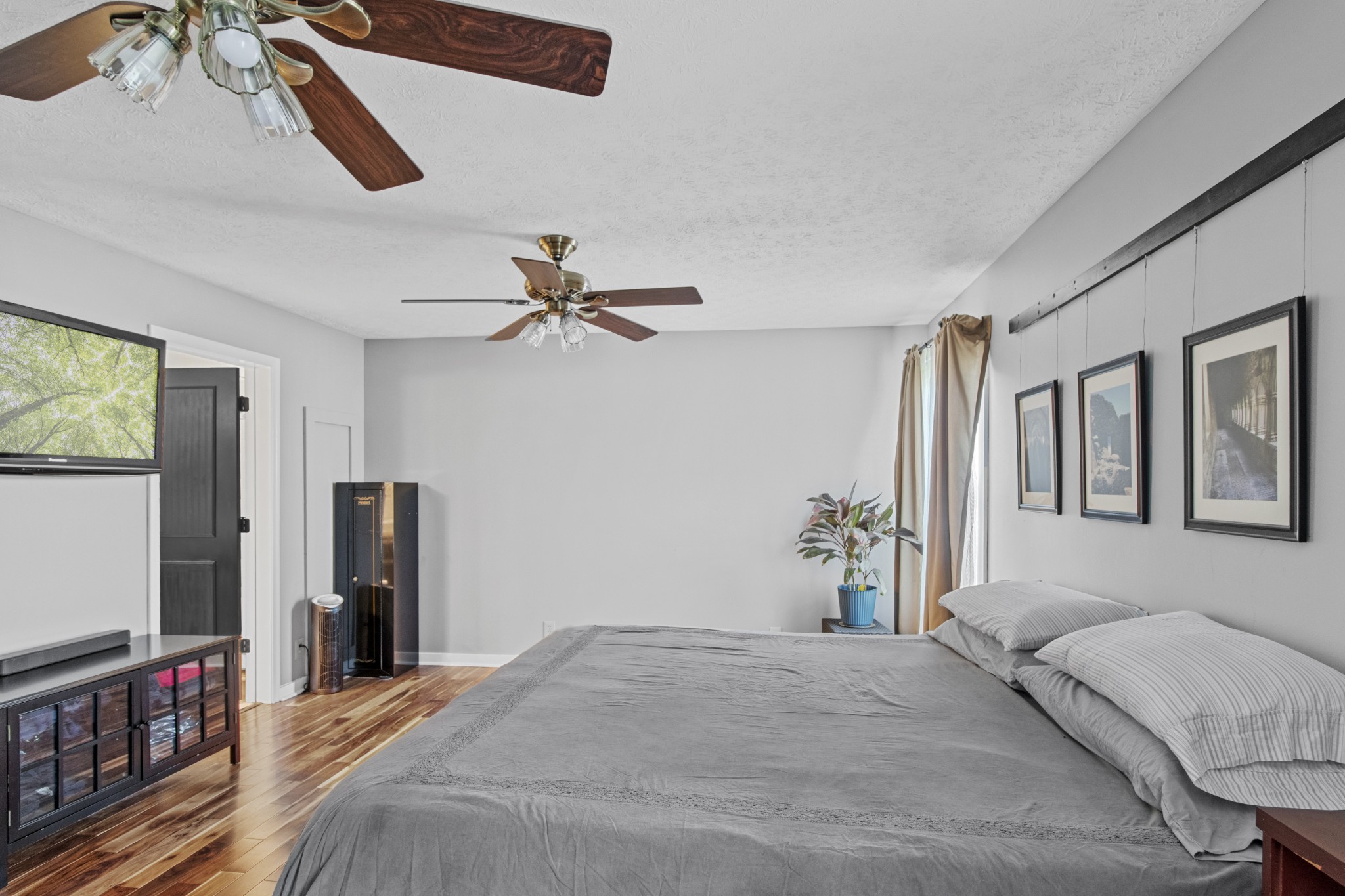 884 Tidwell Road Burns, TN 37029 - Photo 19 of 28 a bedroom with a bed and a flat screen tv