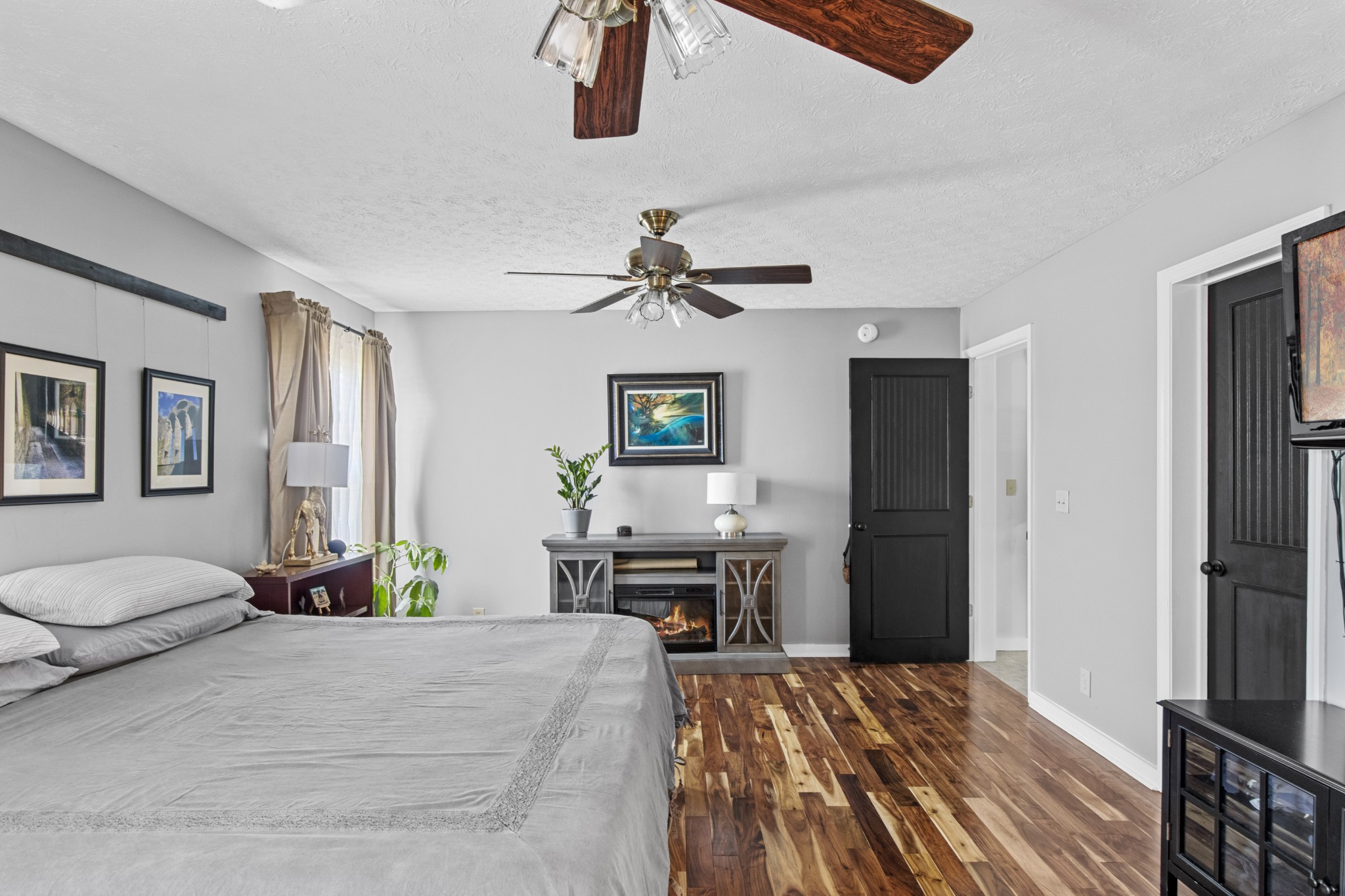 884 Tidwell Road Burns, TN 37029 - Photo 20 of 28 a bedroom with a bed and a chandelier