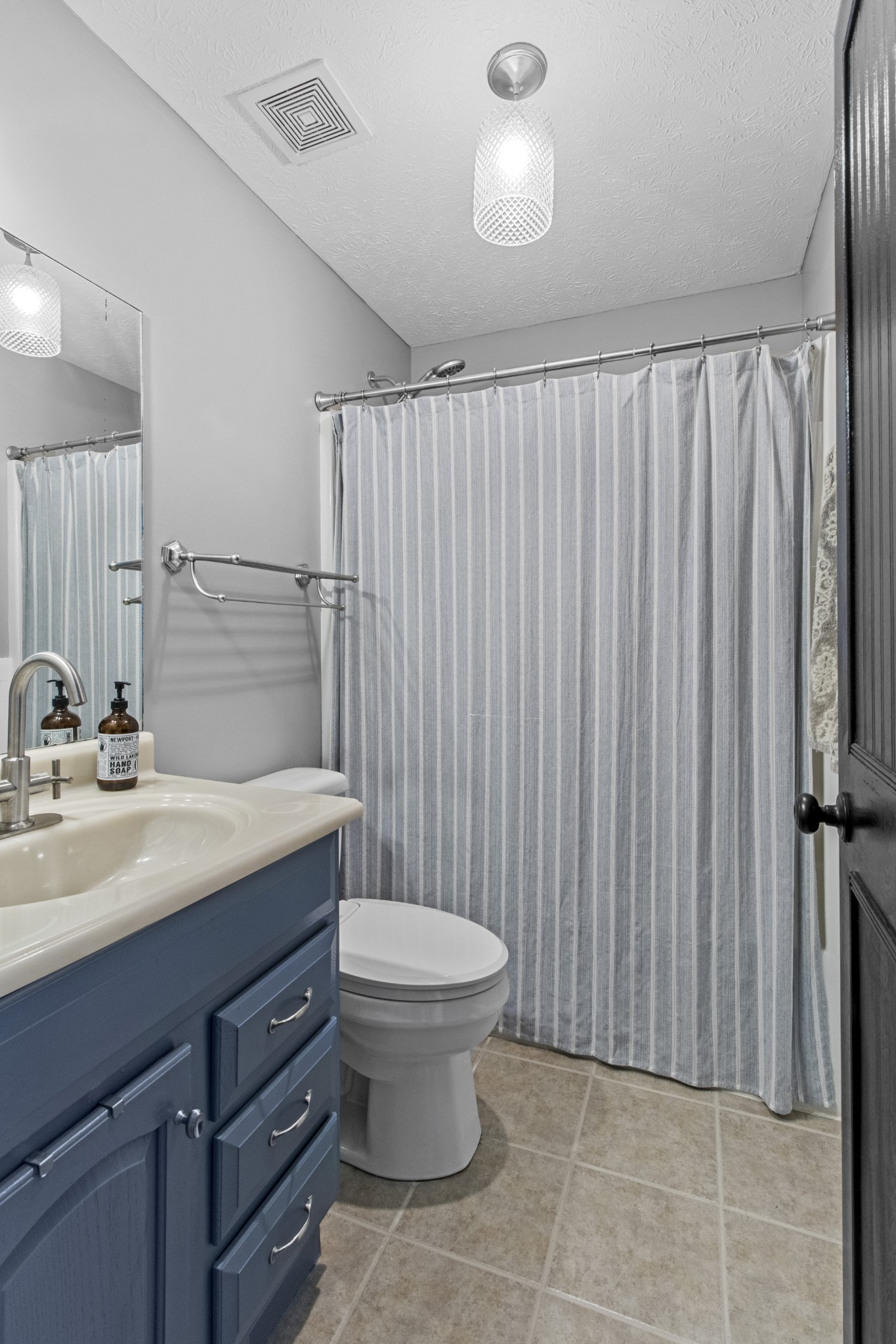884 Tidwell Road Burns, TN 37029 - Photo 27 of 28 a bathroom with a granite countertop sink a toilet and a mirror