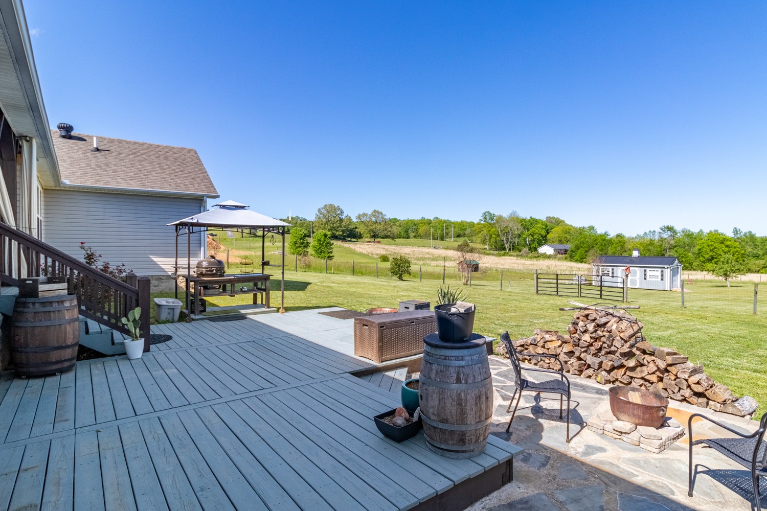 884 Tidwell Road Burns, TN 37029 - Photo 3 of 28 a view of a deck with table and chairs a barbeque with wooden floor and fence