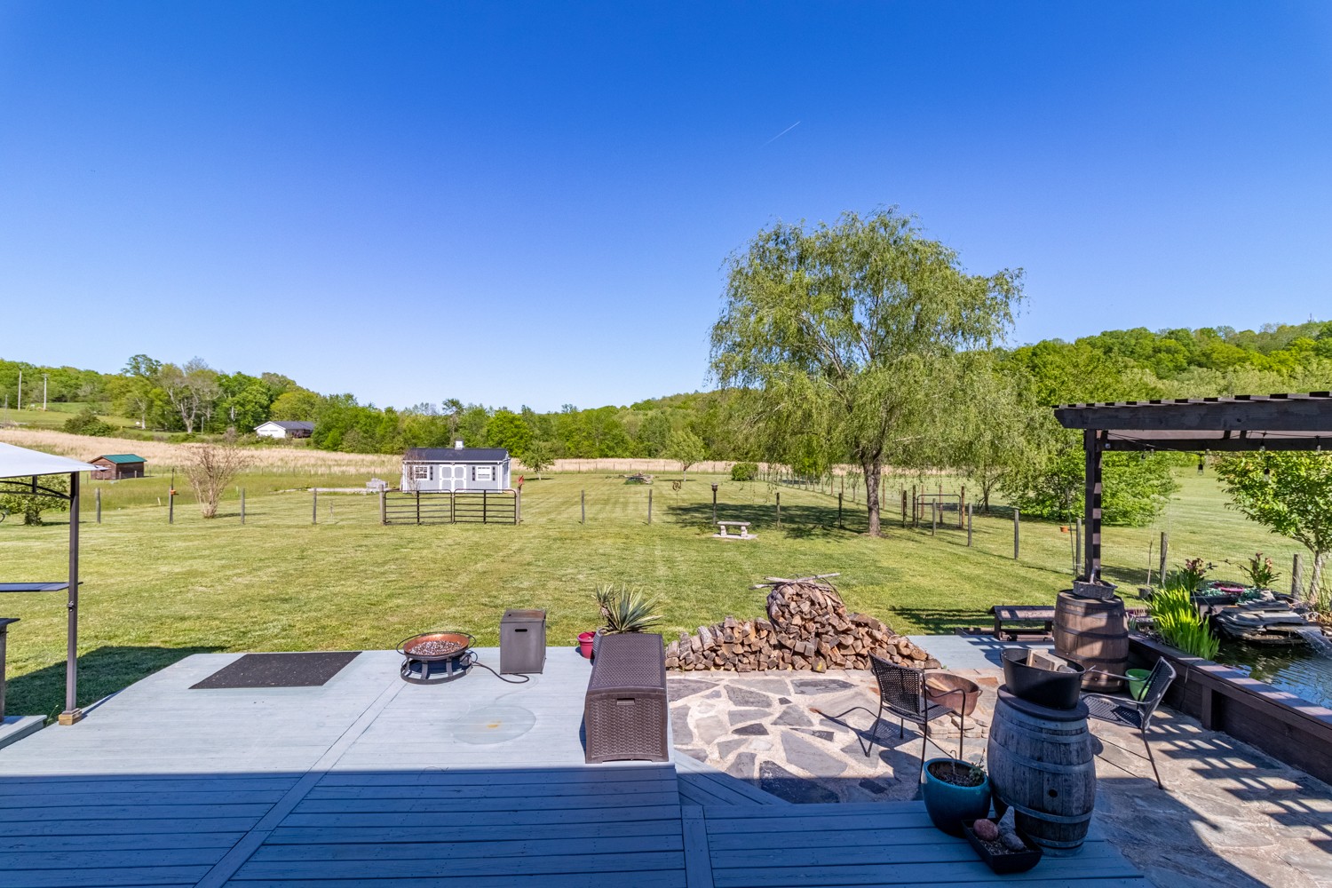 884 Tidwell Road Burns, TN 37029 - Photo 4 of 28 a view of a lake with couches in the patio