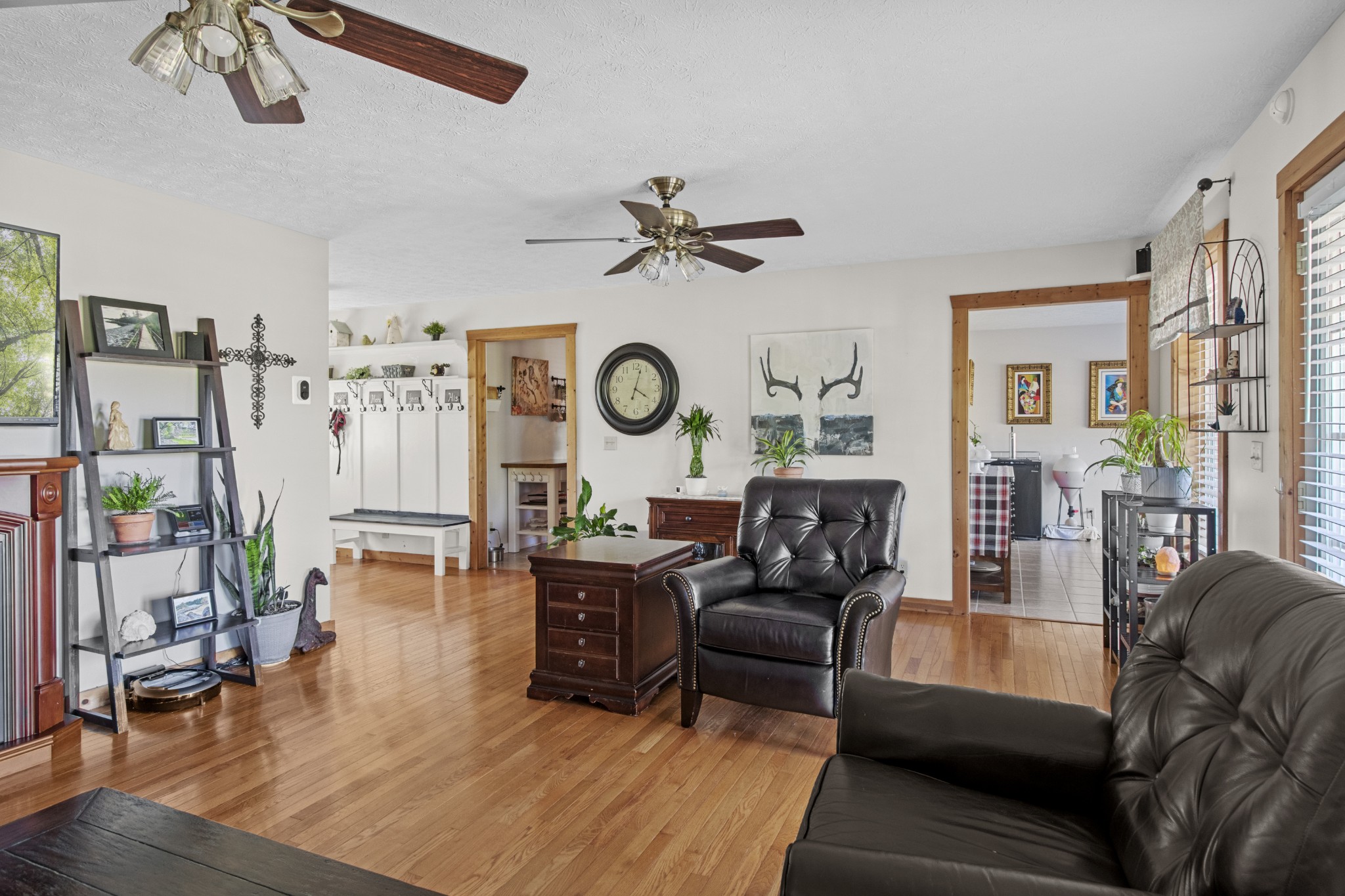 884 Tidwell Road Burns, TN 37029 - Photo 10 of 28 a living room with furniture a clock on wall and a chandelier