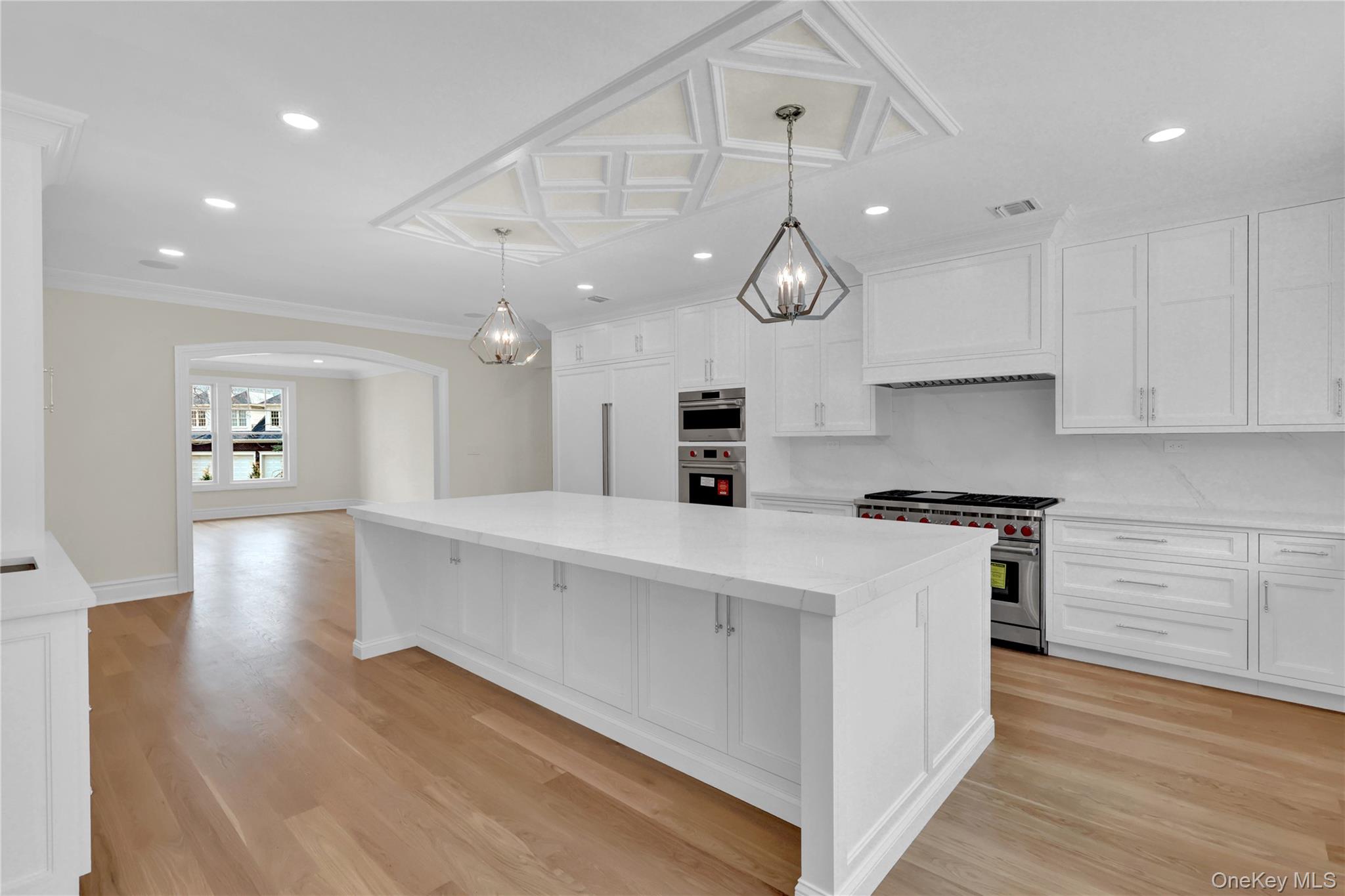 541 Split Rock Road Syosset, NY 11791 - Photo 22 of 50 an open kitchen with white cabinets stainless steel appliances and wooden floor