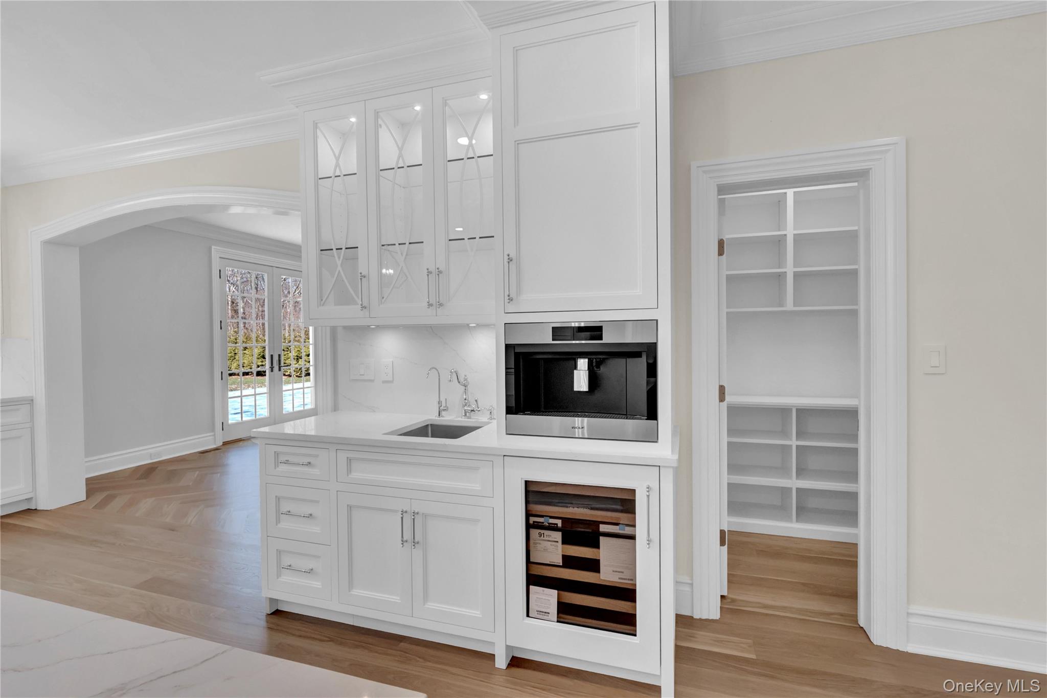 541 Split Rock Road Syosset, NY 11791 - Photo 23 of 50 a kitchen with granite countertop a stove a sink and a microwave oven with white cabinets
