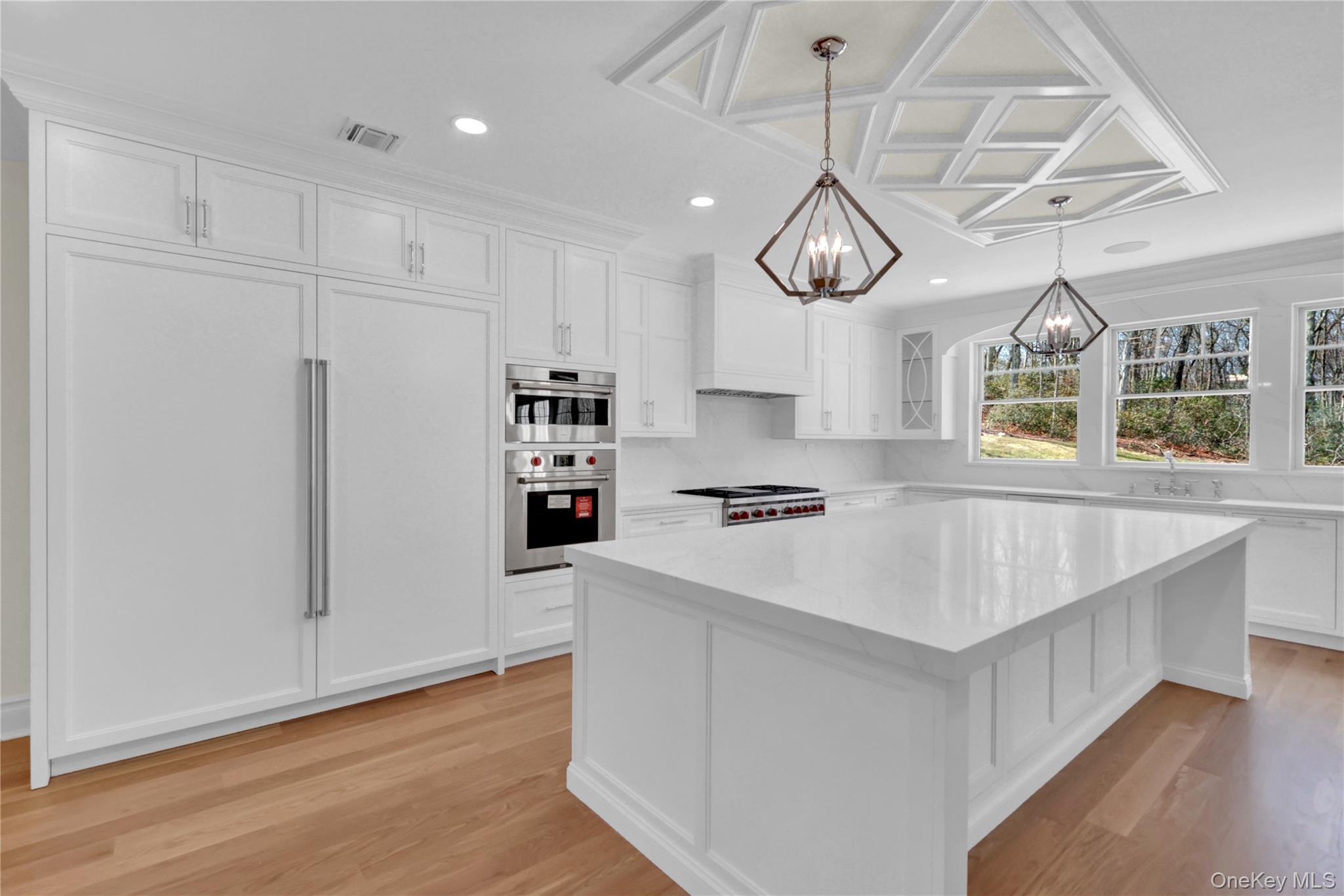 541 Split Rock Road Syosset, NY 11791 - Photo 24 of 50 a kitchen with stainless steel appliances granite countertop a sink a stove and a wooden floors