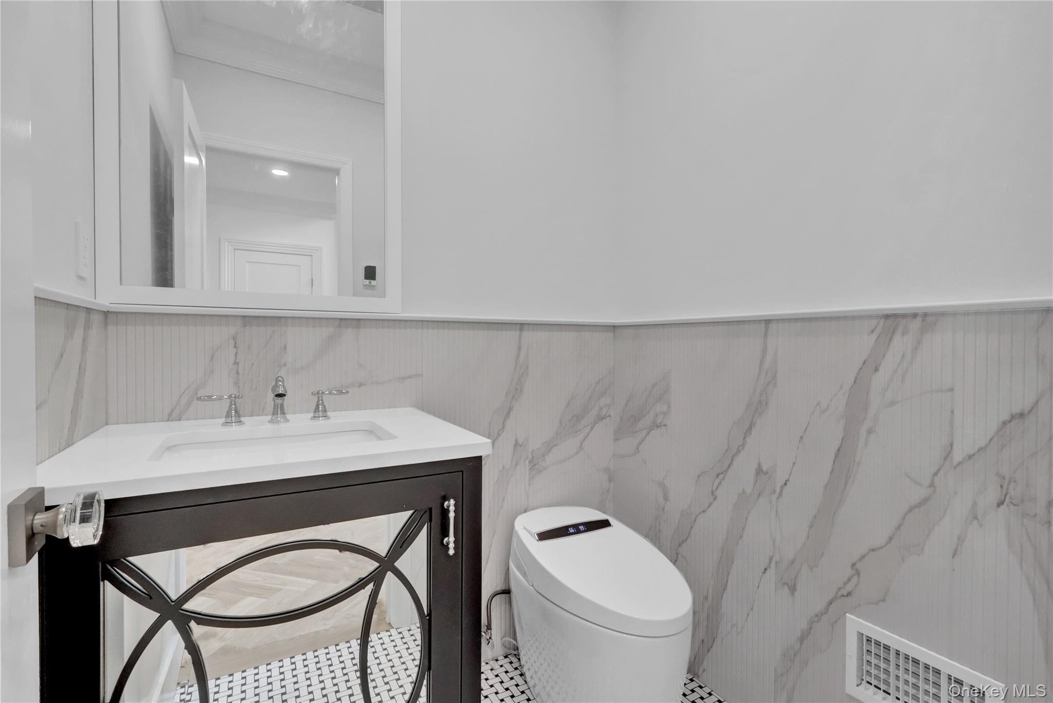 541 Split Rock Road Syosset, NY 11791 - Photo 29 of 50 a bathroom with a sink a toilet and a mirror