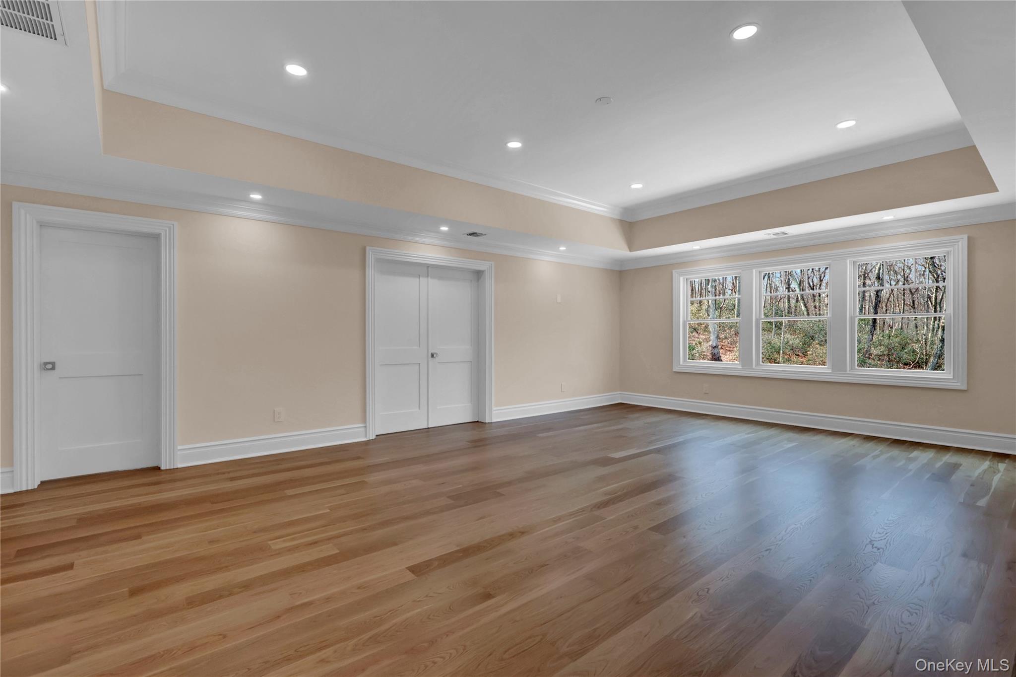 541 Split Rock Road Syosset, NY 11791 - Photo 32 of 50 a view of an empty room with wooden floor and a window