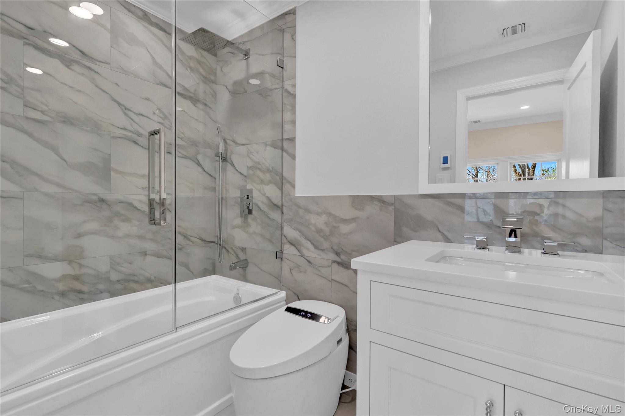 541 Split Rock Road Syosset, NY 11791 - Photo 39 of 50 a bathroom with a sink a toilet and a bathtub