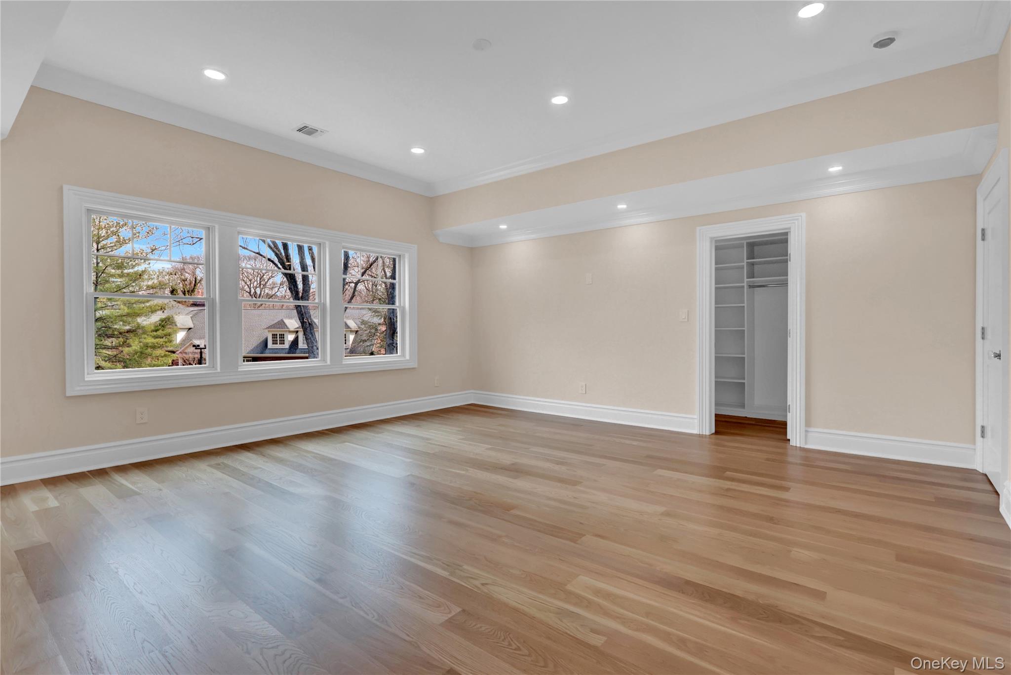 541 Split Rock Road Syosset, NY 11791 - Photo 45 of 50 a view of an empty room with wooden floor and window