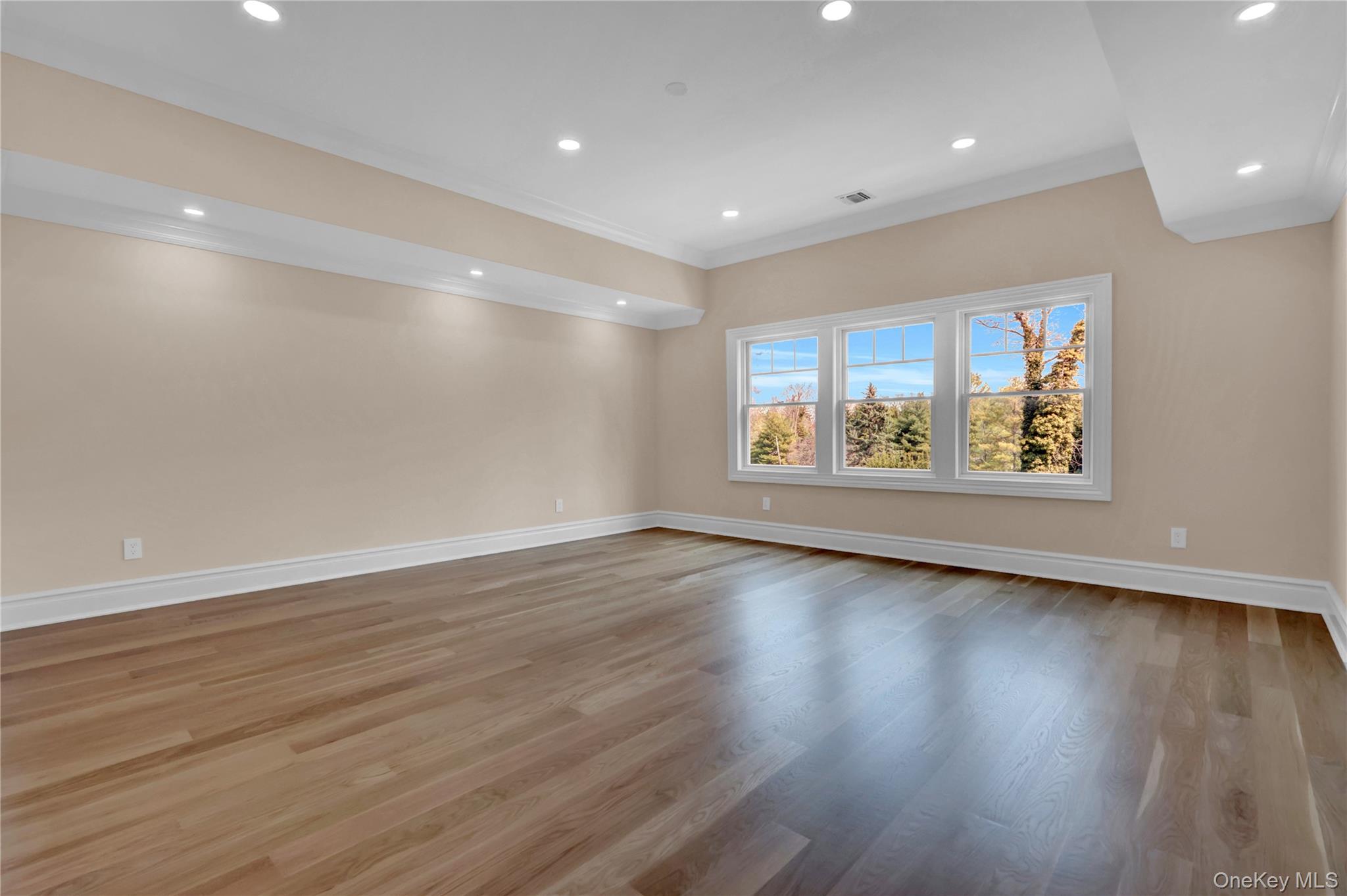 541 Split Rock Road Syosset, NY 11791 - Photo 46 of 50 a view of an empty room with wooden floor and a window