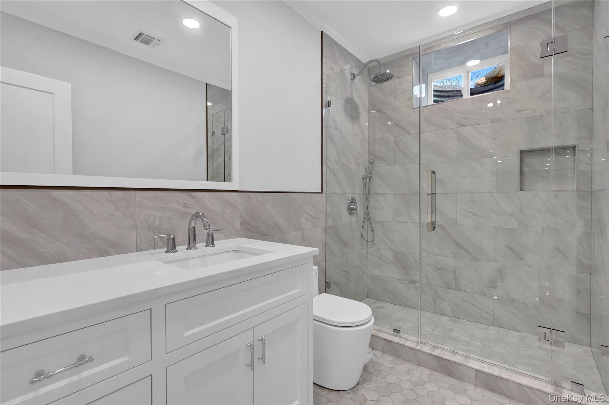 541 Split Rock Road Syosset, NY 11791 - Photo 49 of 50 a bathroom with a sink a toilet and shower