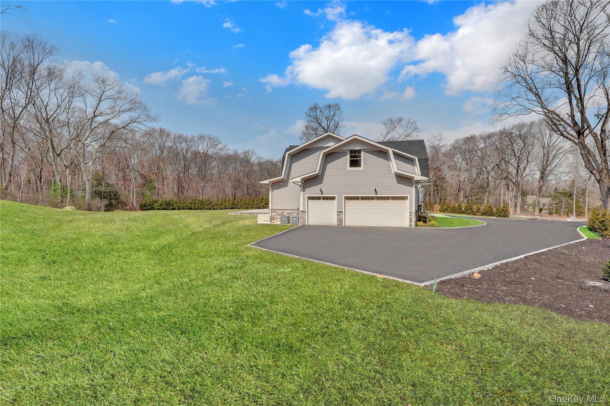 541 Split Rock Road Syosset, NY 11791 - Photo 6 of 50 a front view of a house with a yard and garage