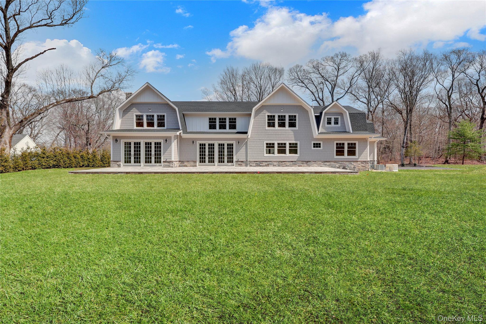 541 Split Rock Road Syosset, NY 11791 - Photo 7 of 50 a front view of a house with garden and trees