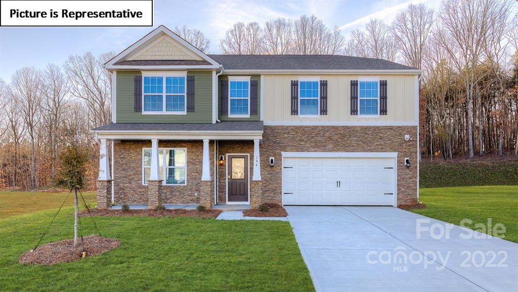 115 Sycamore Xing Court, Unit 75 Locust, NC 28097 - Photo 1 of 29 a front view of a house with a yard