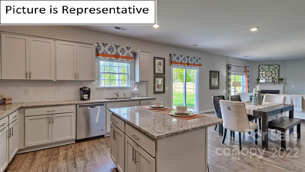115 Sycamore Xing Court, Unit 75 Locust, NC 28097 - Photo 11 of 29 a kitchen with stainless steel appliances granite countertop a stove a sink and a refrigerator