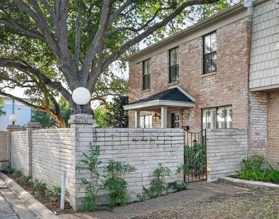 a front view of a house with a garden and plants