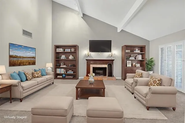a living room with furniture fireplace and a flat screen tv
