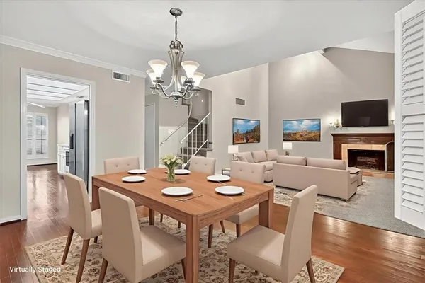 a view of a dining room with furniture wooden floor and a chandelier