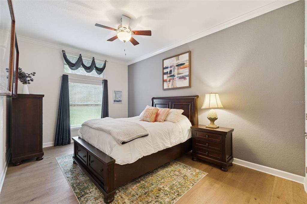 10442 Birch Tree Lane Windermere, FL 34786 - Photo 24 of 69 a bedroom with a bed and a chandelier