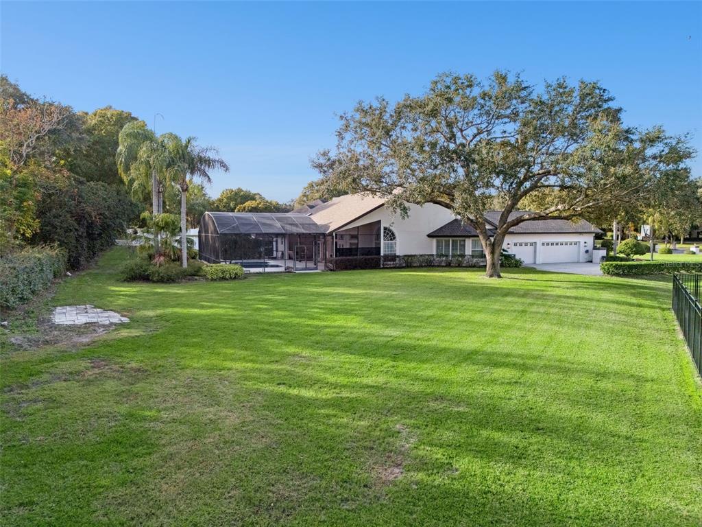 10442 Birch Tree Lane Windermere, FL 34786 - Photo 40 of 69 a view of a house with a big yard and large trees