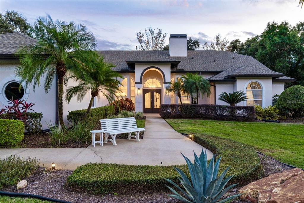 10442 Birch Tree Lane Windermere, FL 34786 - Photo 67 of 69 a front view of a house with garden and porch