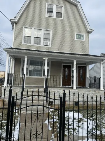 a view of a brick house with large windows