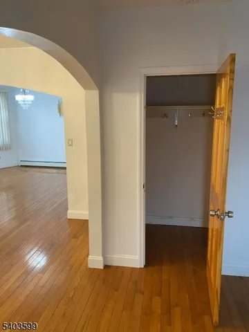 a view of a room with wooden floor